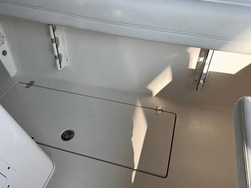 Slide: The Image of 2022 Cobia 280 Center Console boat interior with storage compartment. - 17