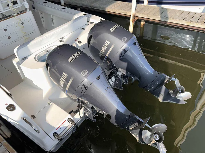 Slide: The Image of 2022 Cobia 280 Center Console with twin Yamaha 200 outboard engines. - 2