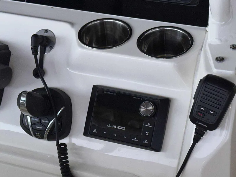 Slide: The Image of 2022 Cobia 280 Center Console dashboard with JL Audio system and Garmin radio. - 21