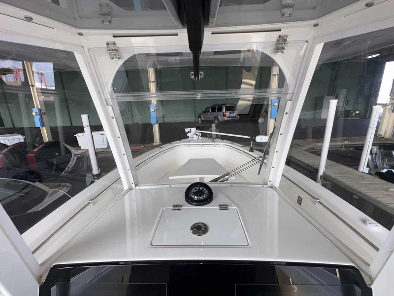 Slide: The Image of 2022 Cobia 280 Center Console boat interior with windshield view. - 22