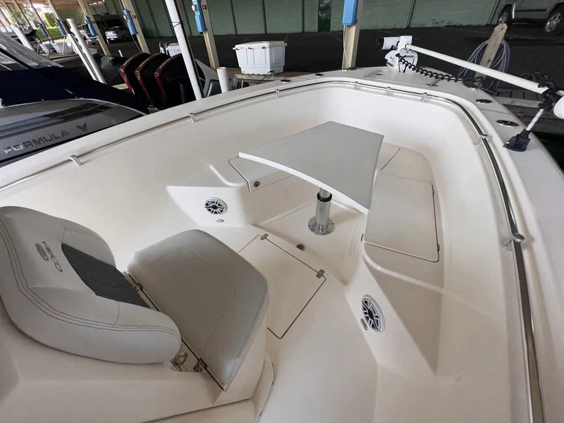 Slide: The Image of 2022 Cobia 280 Center Console boat interior with seating and table. - 23