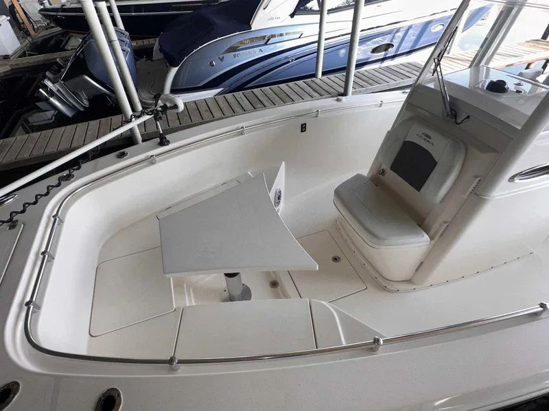 Slide: The Image of 2022 Cobia 280 Center Console boat interior with seating and table. - 24