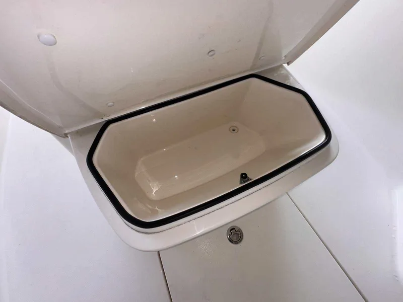 Slide: The Image of Open storage compartment on 2022 Cobia 280 Center Console boat. - 26