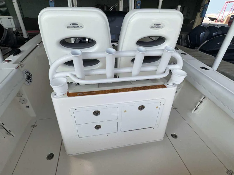 Slide: The Image of 2022 Cobia 280 Center Console boat interior with rod holders and storage compartments. - 7
