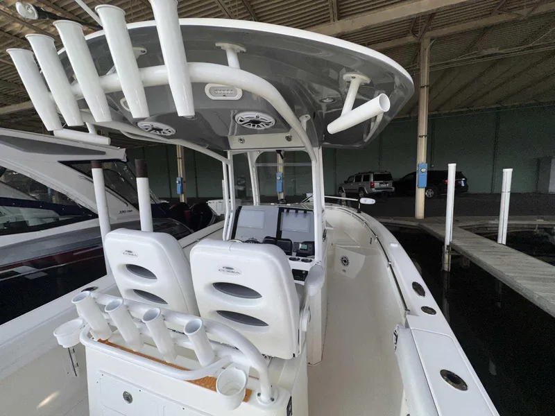 Slide: The Image of 2022 Cobia 280 Center Console boat with rod holders and dual seats. - 8