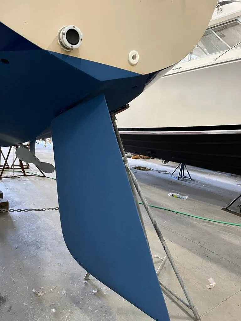 Slide: The Image of 1985 Catalina sailboat rudder and hull in a boatyard. - 2