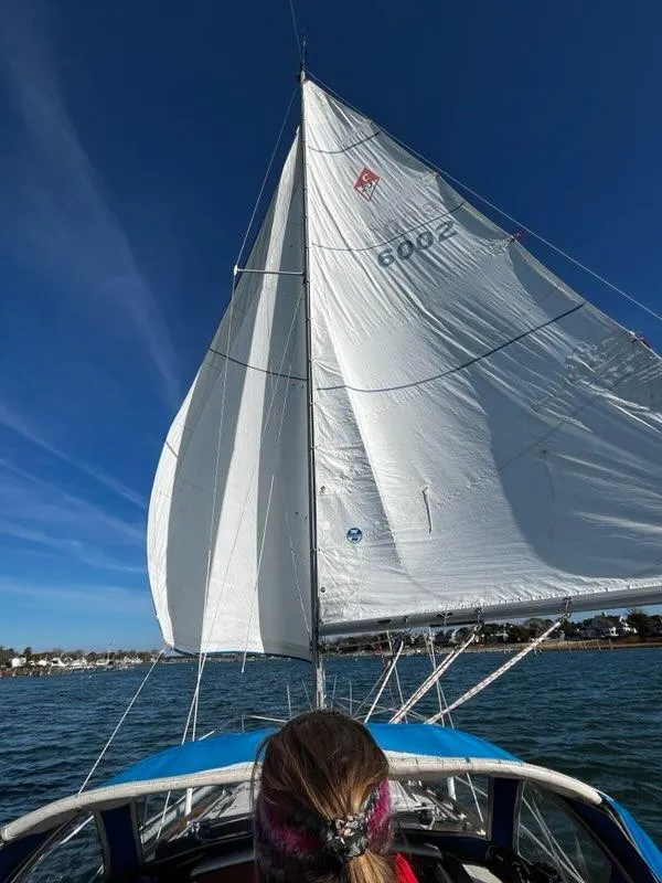 Slide: The Image of 1985 Catalina sailboat on open water under clear blue skies. - 3