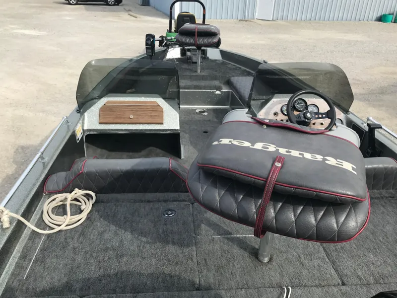 Slide: The Image of 1990 Ranger 375V boat interior with steering wheel and cushioned seats. - 11