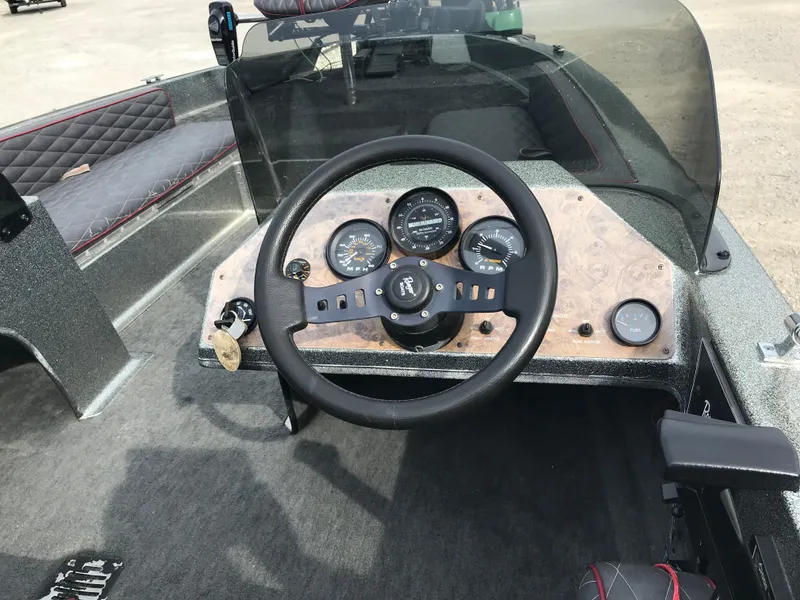 Slide: The Image of 1990 Ranger 375V boat dashboard with steering wheel and instrument panel. - 12