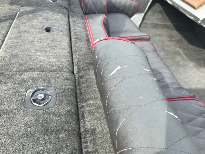 Slide: The Image of 1990 Ranger 375V boat interior with worn gray and red seating. - 13