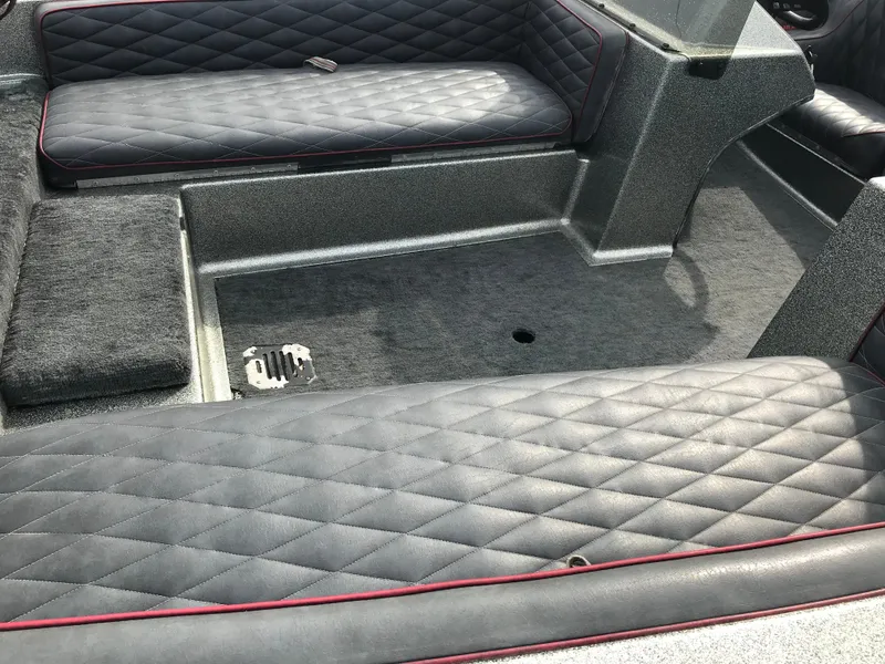 Slide: The Image of 1990 Ranger 375V boat interior with quilted seating and carpeted flooring. - 20