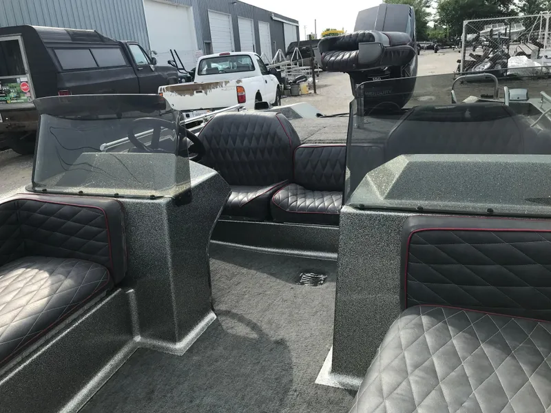 Slide: The Image of 1990 Ranger 375V boat interior with quilted seats and dual consoles. - 21