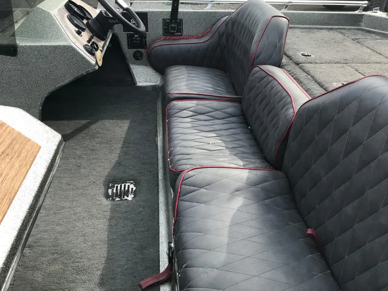 Slide: The Image of 1990 Ranger 375V boat interior with quilted seats and steering console. - 22
