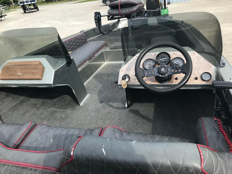 Slide: The Image of 1990 Ranger 375V boat interior with steering wheel and dashboard controls. - 25