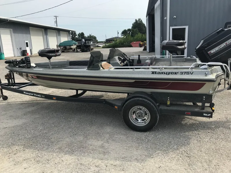 Slide: The Image of 1990 Ranger 375V fishing boat on trailer, parked outdoors. - 7