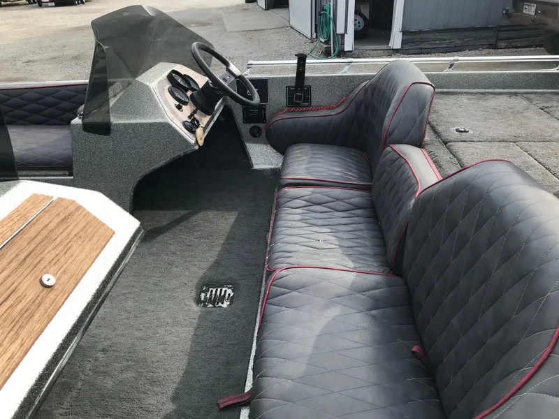 Slide: The Image of 1990 Ranger 375V boat interior with quilted seats and steering console. - 9