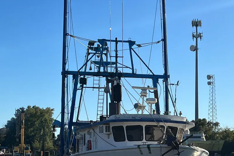 Slide: The Image of 1971 Butterfish Fishing Trawler docked under clear blue sky. - 2