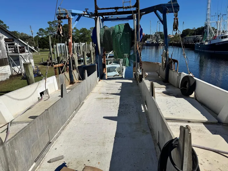 Slide: The Image of 1971 Butterfish Fishing Trawler docked, showcasing deck and equipment. - 20
