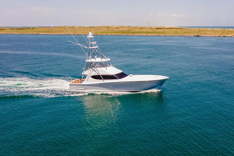 Slide: The Image of 2014 Hatteras 63 GT yacht cruising on open water. - 12