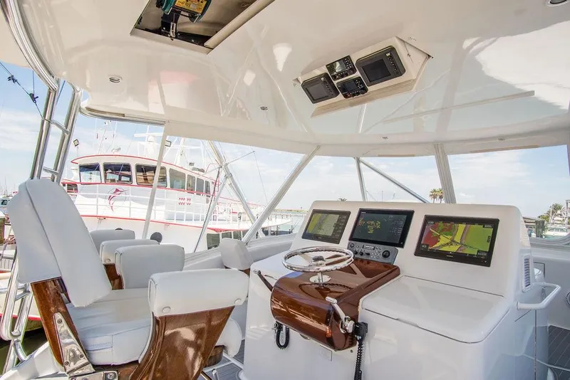 Slide: The Image of Interior helm of 2014 Hatteras 63 GT yacht with modern navigation equipment. - 14