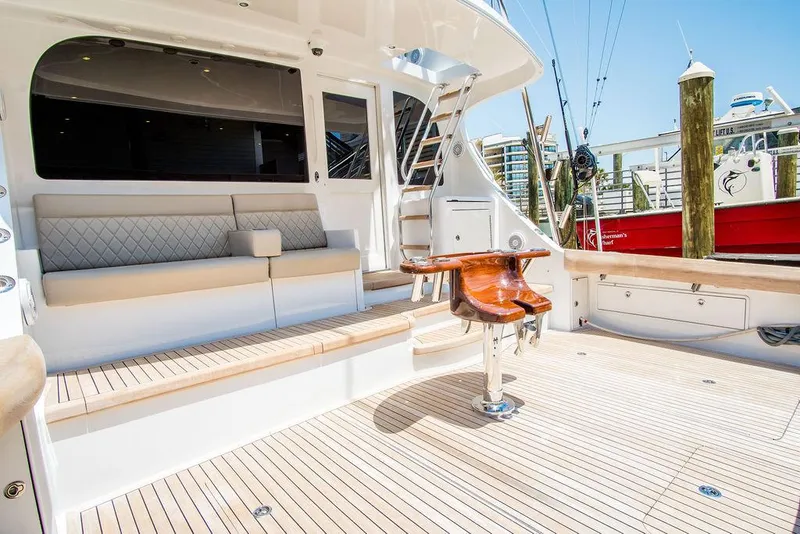 Slide: The Image of Luxurious 2014 Hatteras 63 GT yacht deck with seating and fishing chair. - 17