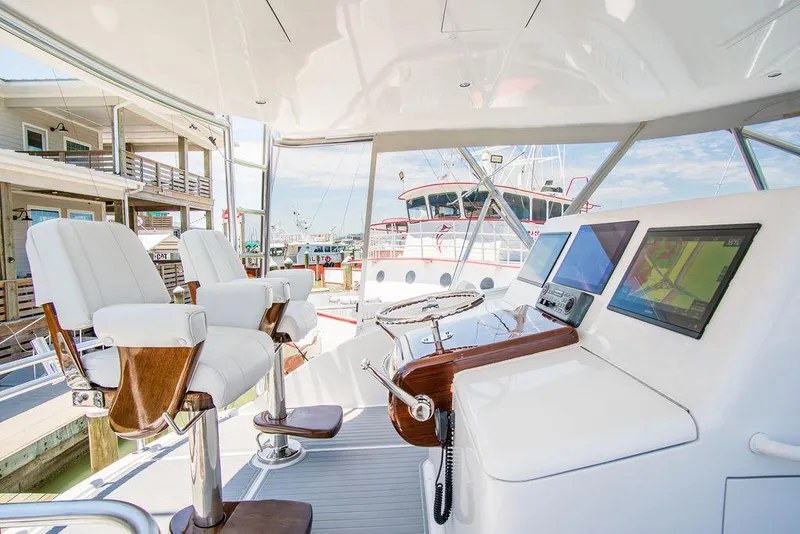 Slide: The Image of Luxurious 2014 Hatteras 63 GT yacht helm with modern controls and seating. - 30