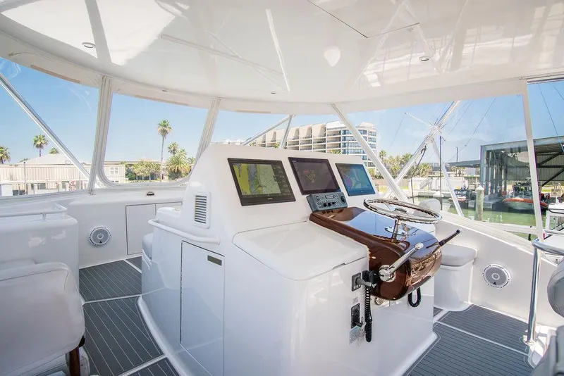 Slide: The Image of Luxurious 2014 Hatteras 63 GT yacht helm with modern navigation equipment and panoramic views. - 31