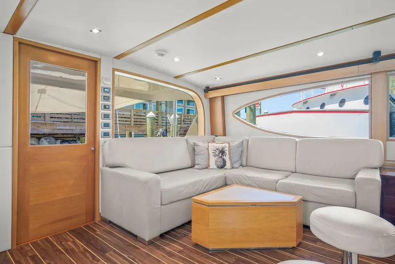 Slide: The Image of Luxurious interior of 2014 Hatteras 63 GT yacht with modern seating and wooden accents. - 38