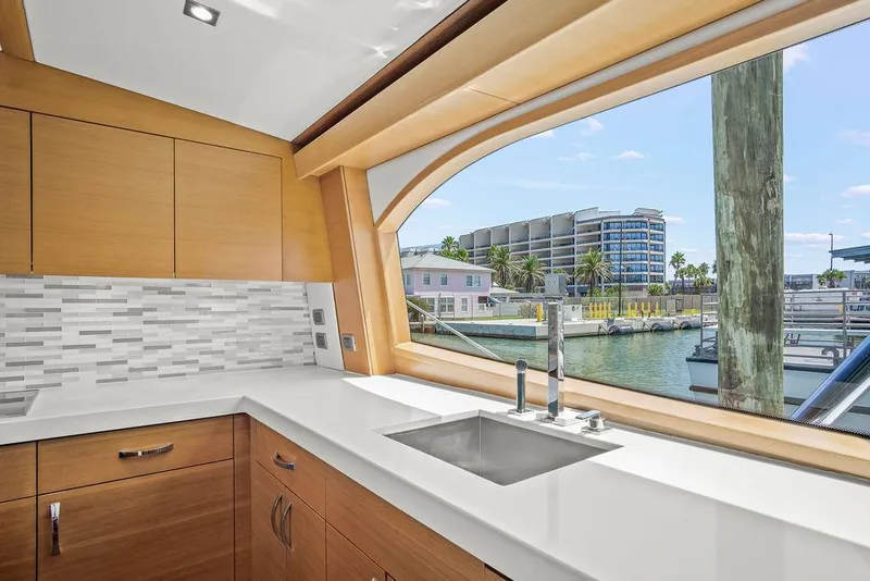 Slide: The Image of Luxurious kitchen interior of 2014 Hatteras 63 GT yacht with waterfront view. - 44
