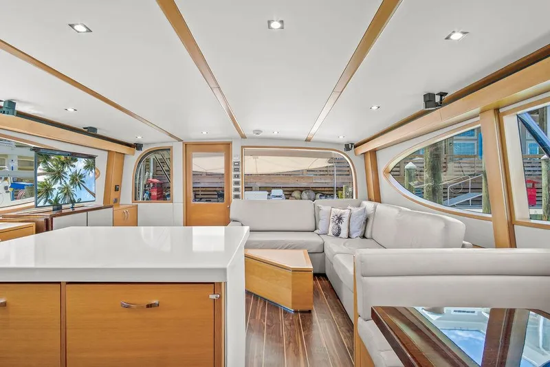 Slide: The Image of Luxurious interior of 2014 Hatteras 63 GT yacht with modern furnishings and large windows. - 47