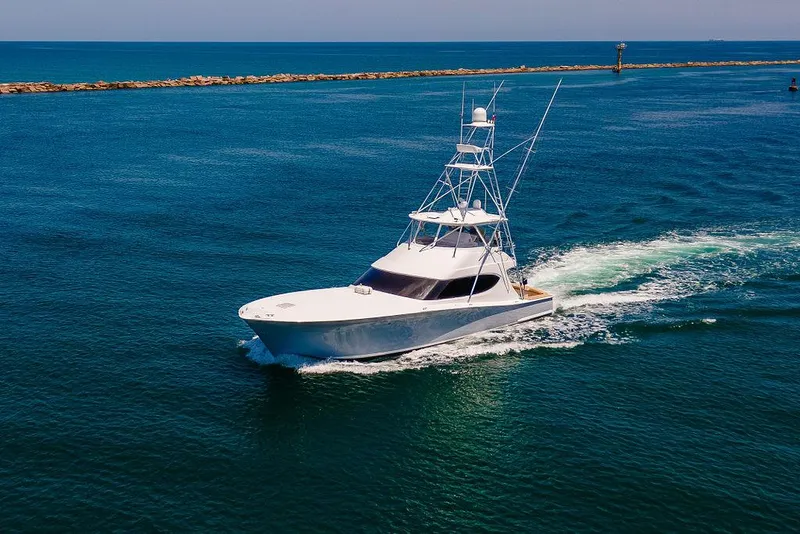 Slide: The Image of 2014 Hatteras 63 GT yacht cruising on open blue water. - 6