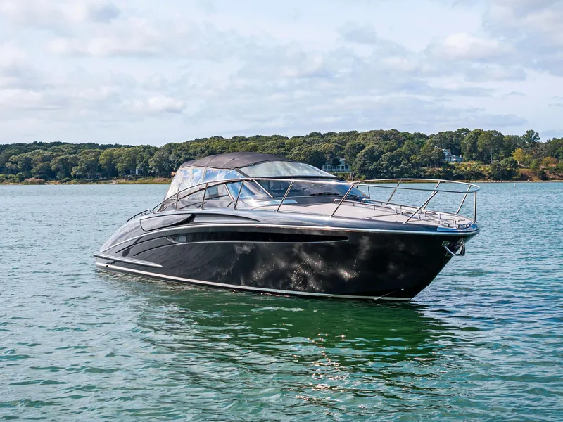 Slide: The Image of 2016 Riva 44 Rivarama Super yacht on serene water with lush green shoreline. - 11