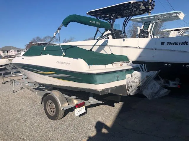 Slide: The Image of 2005 Four Winns 180 Horizon LE boat on trailer with green cover. - 10