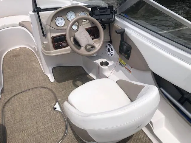 Slide: The Image of 2005 Four Winns 180 Horizon LE boat interior with steering wheel and dashboard controls. - 6