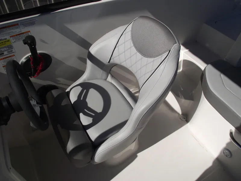 Slide: The Image of 2025 Bayliner D20 boat interior with modern steering wheel and cushioned seat. - 11