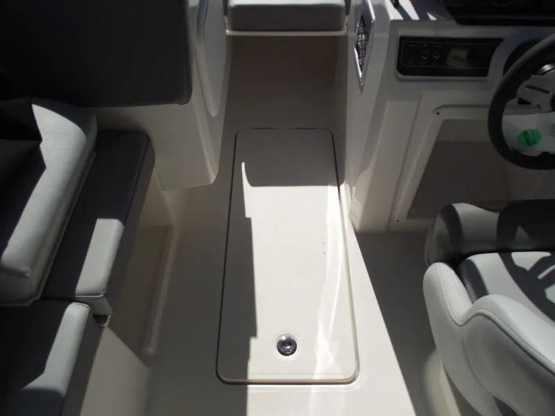 Slide: The Image of Interior view of 2025 Bayliner D20 boat cockpit with seating and steering wheel. - 14