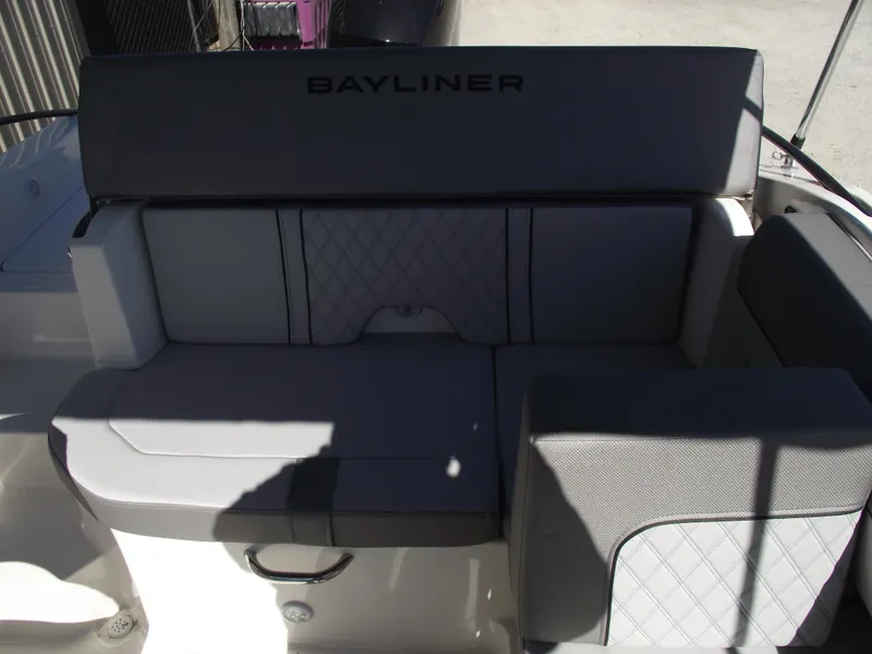 Slide: The Image of 2025 Bayliner D20 boat interior seating with gray upholstery and Bayliner logo. - 19