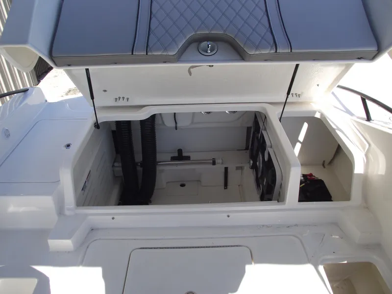 Slide: The Image of 2025 Bayliner D20 boat storage compartment with open hatch, showcasing interior space. - 22