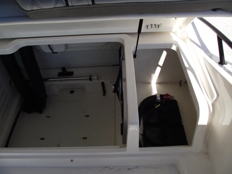 Slide: The Image of Interior storage compartments of a 2025 Bayliner D20 boat. - 23