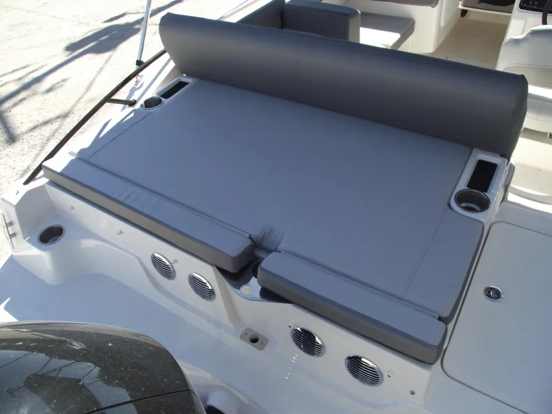 Slide: The Image of 2025 Bayliner D20 boat with gray cushioned seating and cup holders. - 28