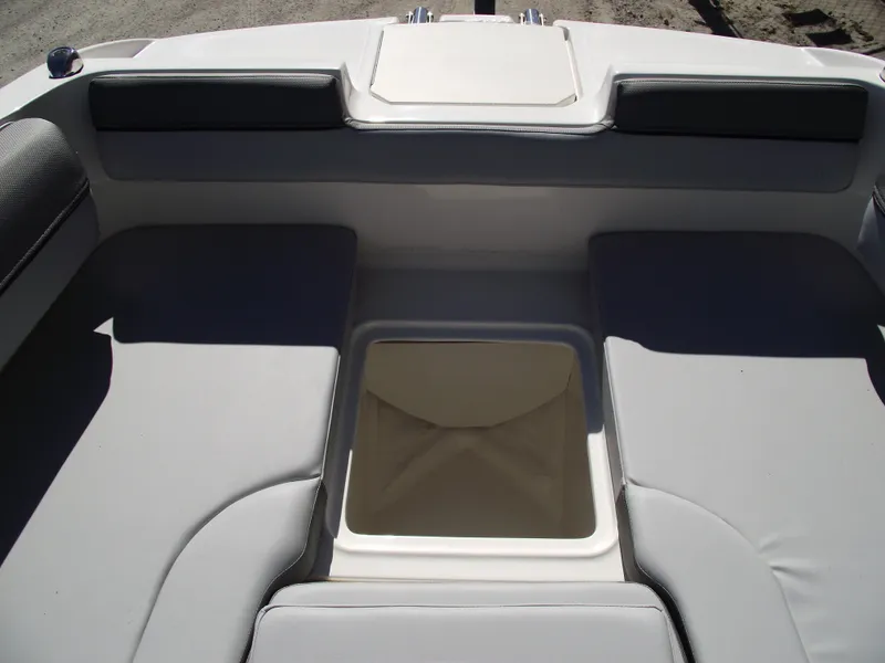 Slide: The Image of Bayliner D20 2025 boat interior with cushioned seating and storage compartment. - 7