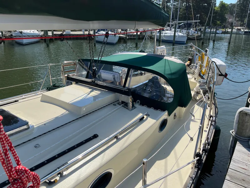 Slide: The Image of Sailboat Alajuela 38, 2016 model, docked in a marina with green canopy. - 15