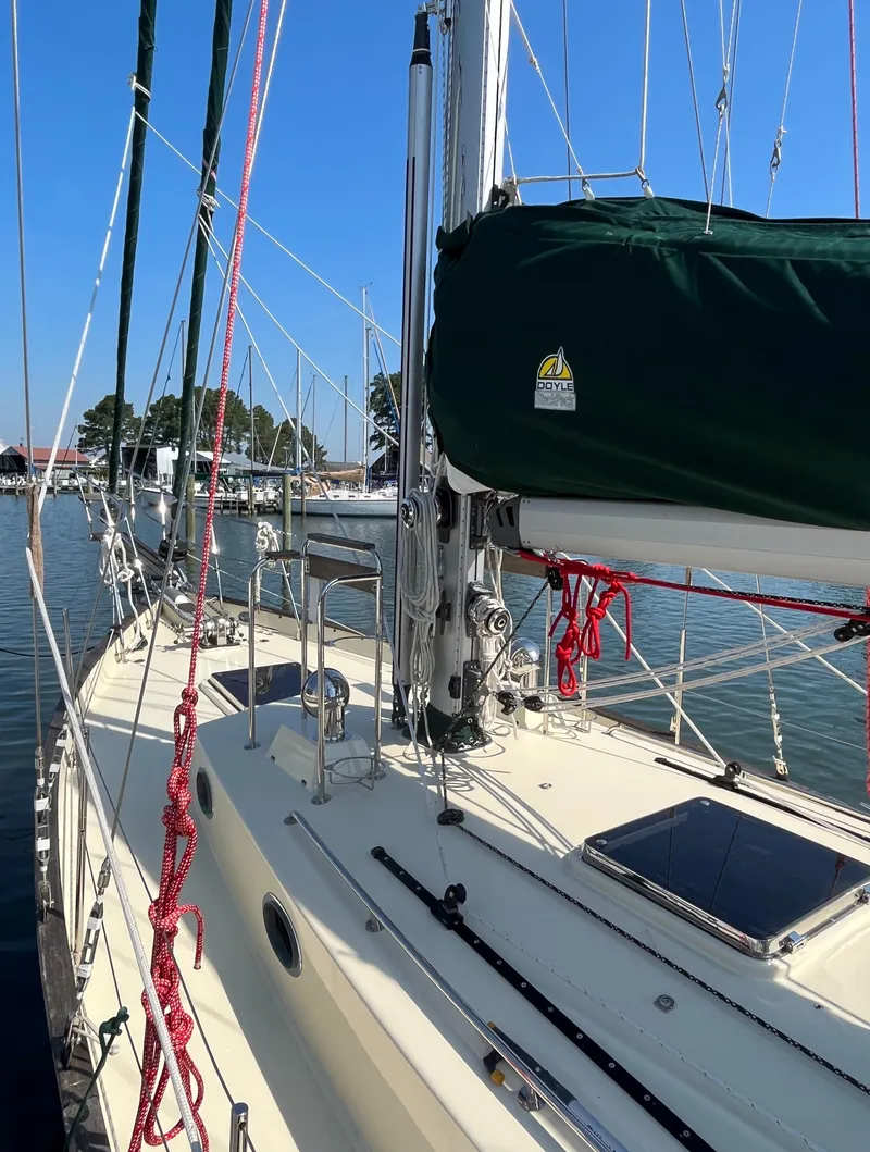 Slide: The Image of Sailboat Alajuela 38, 2016 model, docked with green sail cover and red ropes. - 18