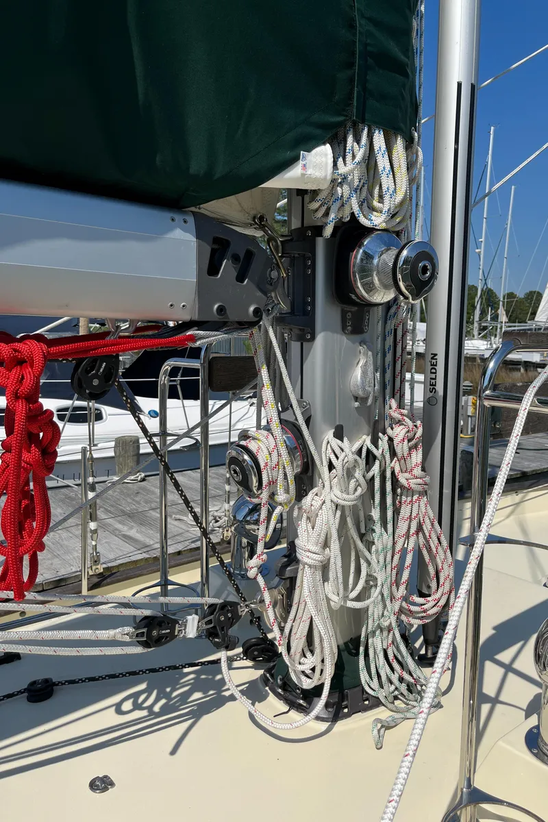 Slide: The Image of Sailboat rigging on a 2016 Alajuela 38, featuring ropes and winches at a marina. - 29