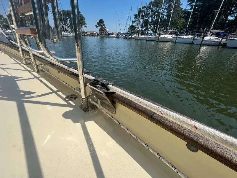 Slide: The Image of Sailboat deck view, Alajuela 38, 2016, docked at marina with calm water and moored boats. - 30