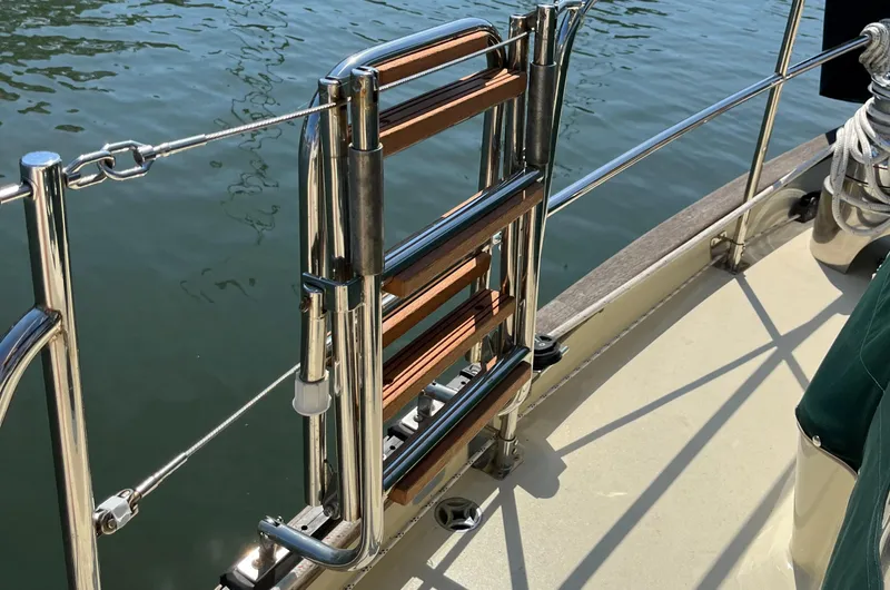 Slide: The Image of Stainless steel and wood ladder on 2016 Alajuela 38 sailboat deck by water. - 31