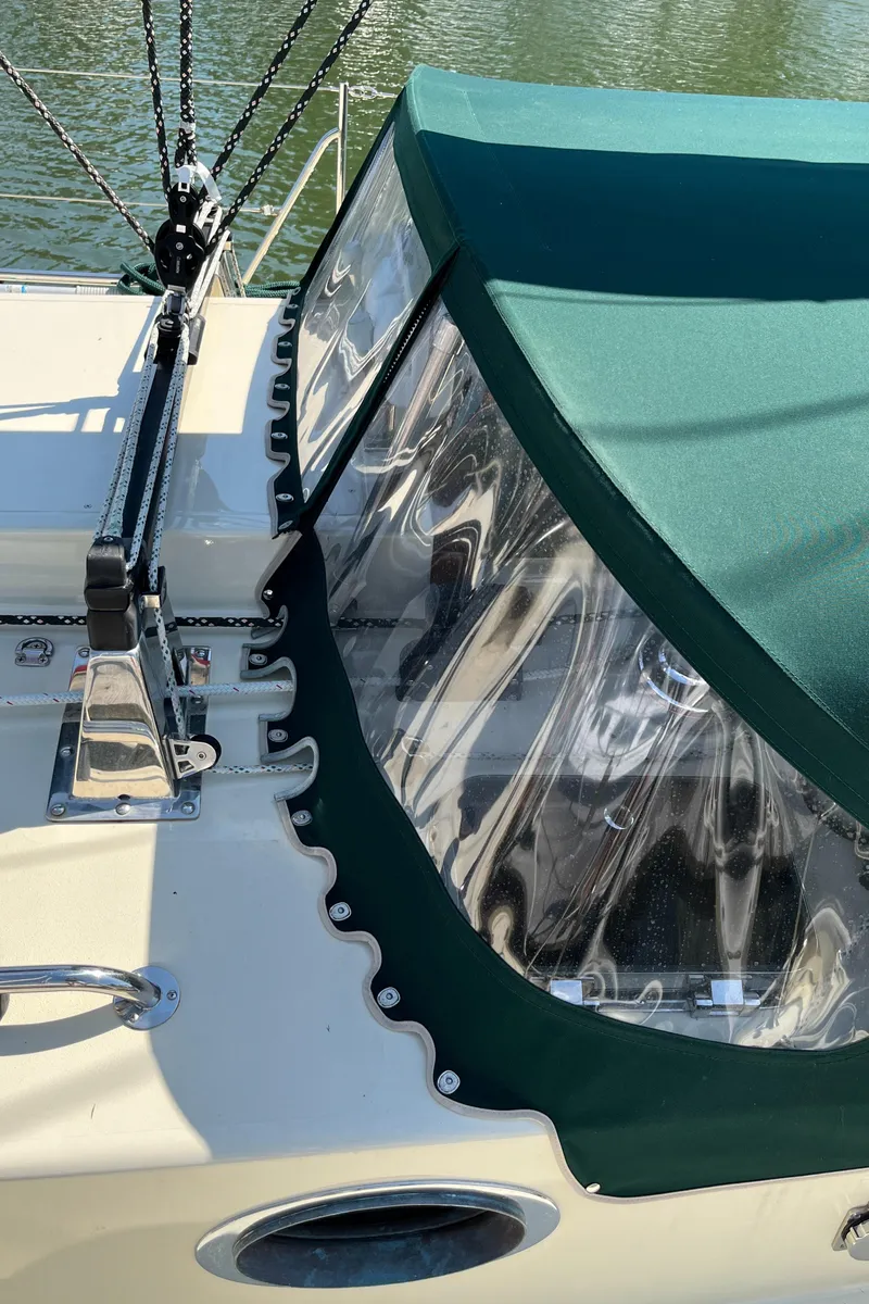 Slide: The Image of Sailboat cockpit with green canopy, Alajuela 38, 2016 model, docked on calm water. - 32