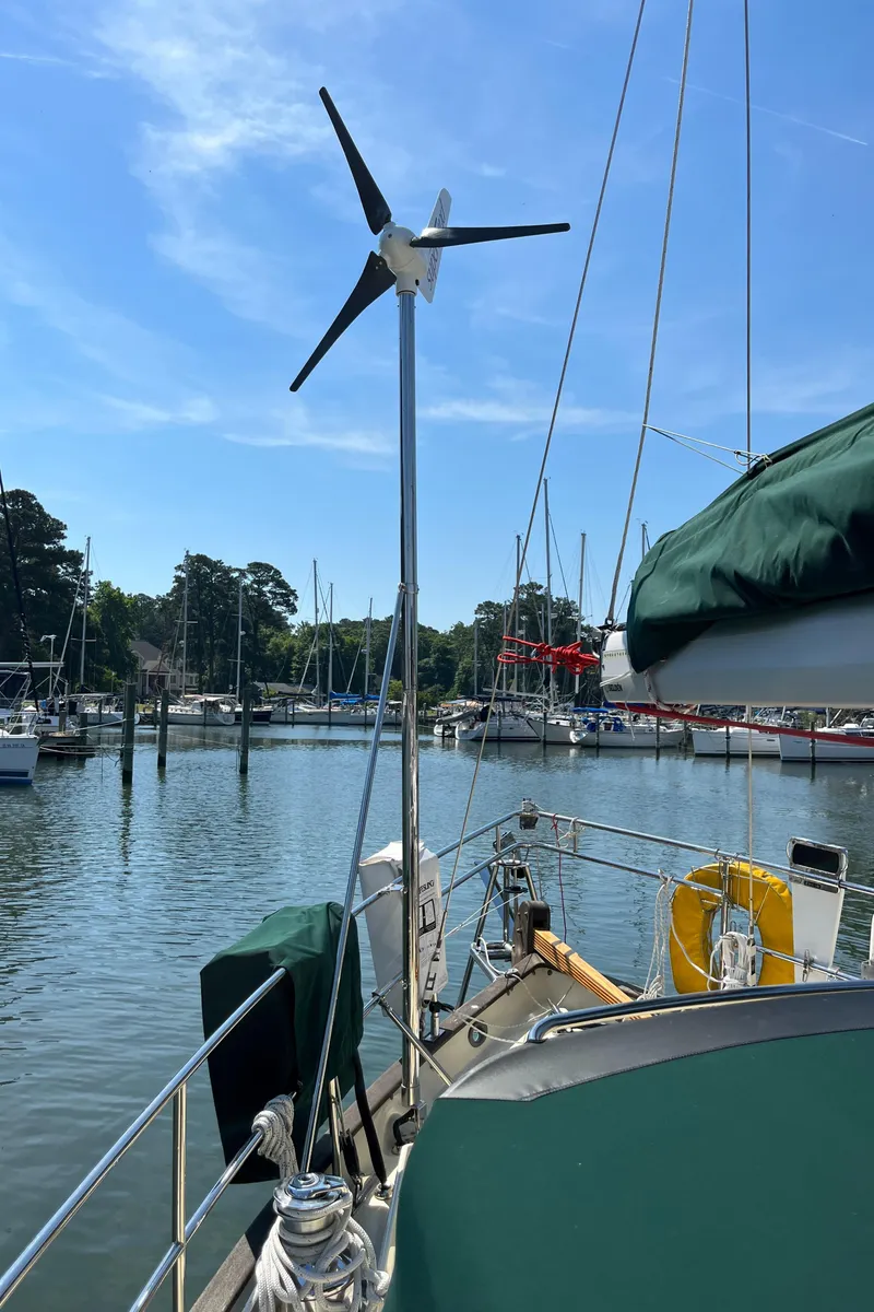 Slide: The Image of Sailboat Alajuela 38 (2016) with wind turbine docked in a marina. - 36