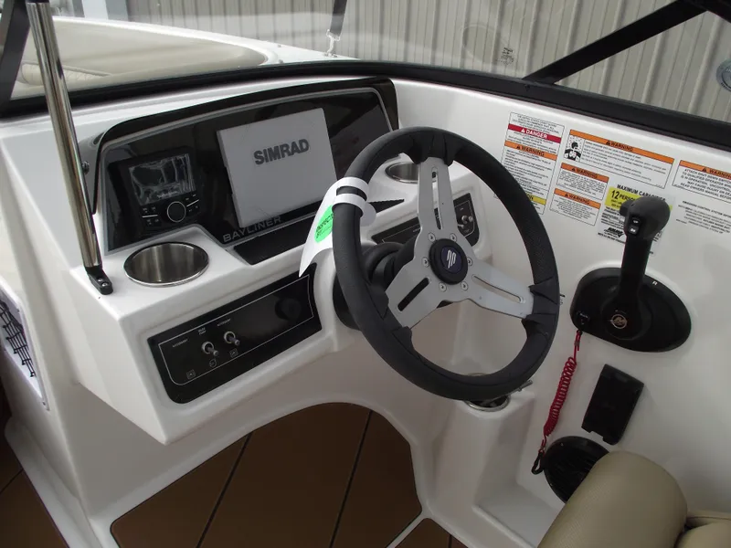 Slide: The Image of 2025 Bayliner D22 boat dashboard with steering wheel and Simrad display. - 11