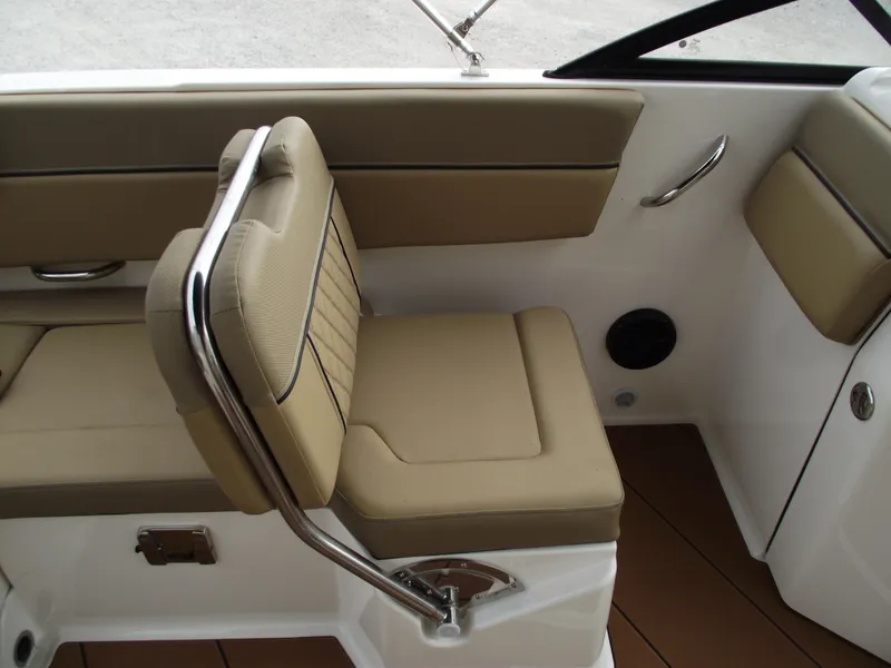 Slide: The Image of 2025 Bayliner D22 interior seating with beige upholstery and stainless steel accents. - 19